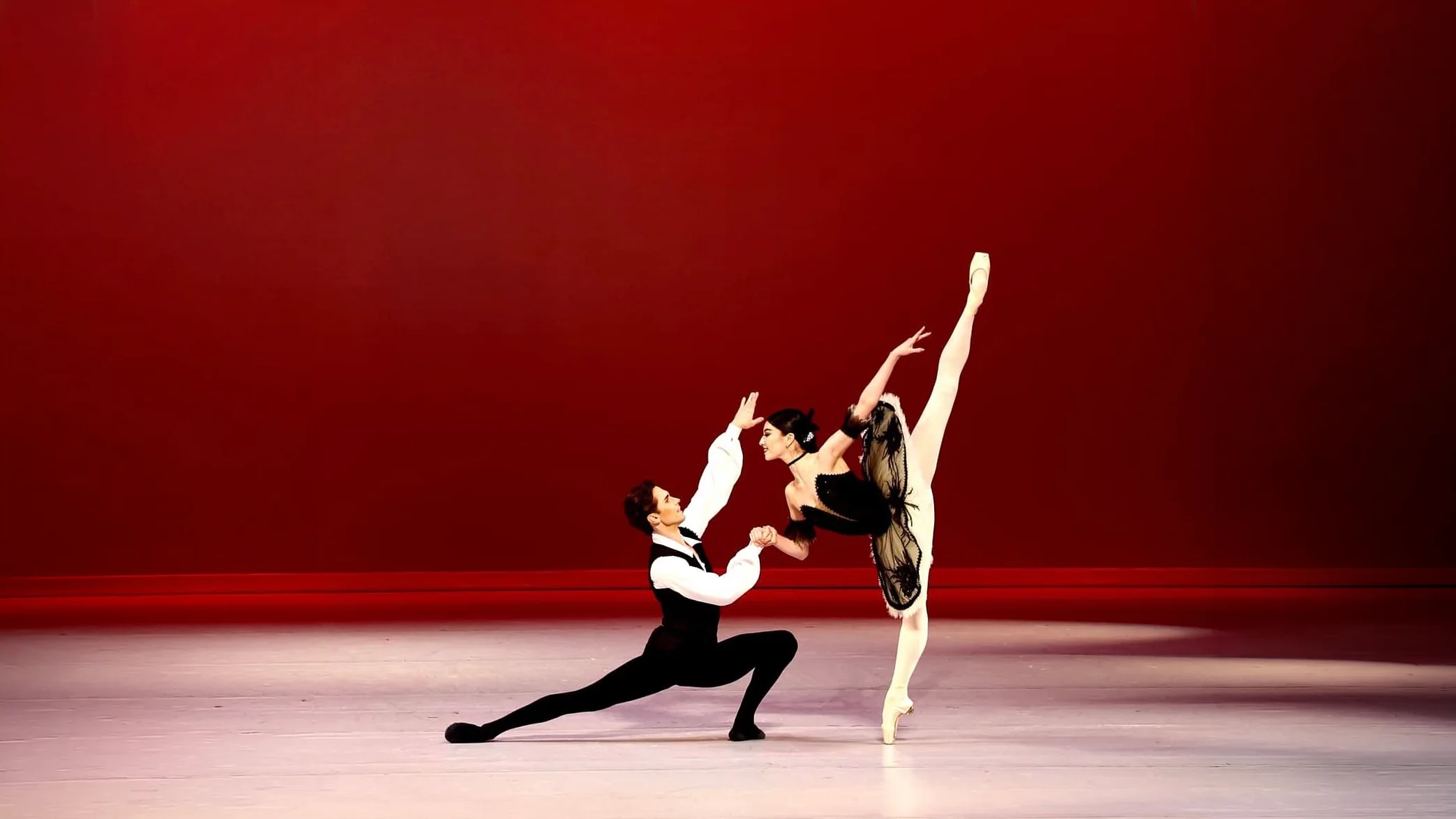 Phoenix Ballet dancers performing together on a red-lit stage